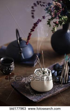 Stock Image - Incense burning on table. Fotosearch