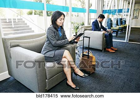 Stock Photography - Japanese businesswoman using digital tablet in office. Fotosearch
