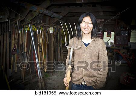 Japanese gardener holding pitchfork in barn View Large Photo Image Stock Photography - Japanese gardener holding pitchfork in barn. Fotosearch