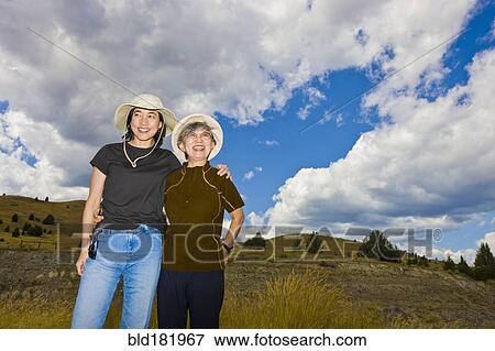 Japanese mother and daughter standing on hillside View Large Photo Image Stock Photo - Japanese mother and daughter standing on hillside. Fotosearch