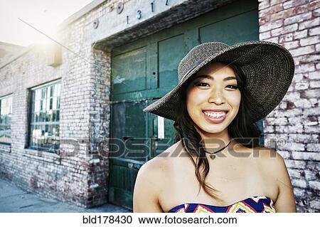 Stock Image - Japanese woman smiling outdoors. Fotosearch