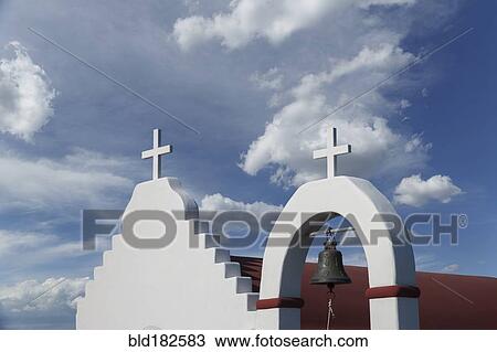 Stock Image - Low angle view of crosses on traditional roof. Fotosearch