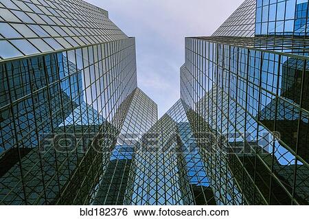Stock Photograph - Low angle view of modern highrise building. Fotosearch