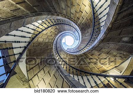 Stock Image - Low angle view of spiral staircase. Fotosearch