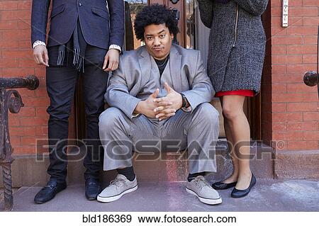 Stock Photo - Man making a face on front stoop. Fotosearch