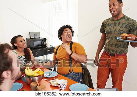Man serving food to friends at party View Large Photo Image Stock Image - Man serving food to friends at party. Fotosearch
