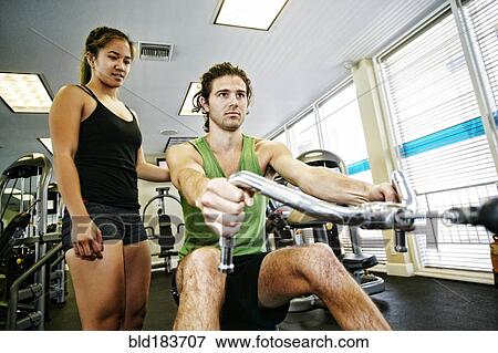 Man working out with trainer in gymnasium View Large Photo Image Stock Photo - Man working out with trainer in gymnasium. Fotosearch