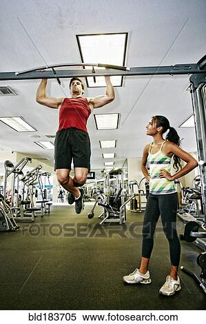 Man working out with trainer in gymnasium View Large Photo Image Stock Photography - Man working out with trainer in gymnasium. Fotosearch