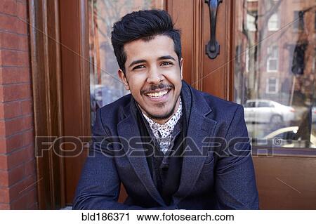 Middle Eastern man smiling on front stoop View Large Photo Image Stock Image - Middle Eastern man smiling on front stoop. Fotosearch