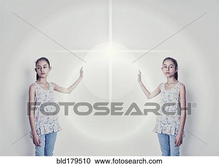 Mirror image of mixed race girl reaching for light View Large Photo Image Stock Image - Mirror image of mixed race girl reaching for light. Fotosearch