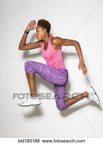Stock Photo - Mixed race athlete sprinting. Fotosearch
