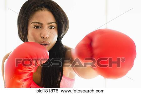 Mixed race boxer punching View Large Photo Image Stock Photograph - Mixed race boxer punching. Fotosearch