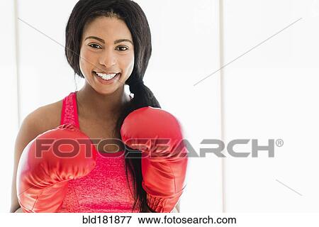 Stock Photo - Mixed race boxer wearing boxing gloves. Fotosearch