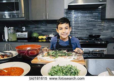 Mixed race boy cooking in kitchen View Large Photo Image Stock Photography - Mixed race boy cooking in kitchen. Fotosearch