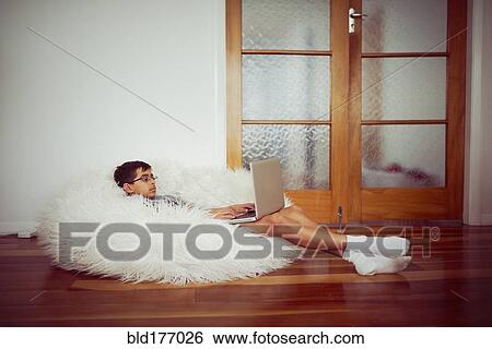 Mixed race boy using laptop in beanbag View Large Photo Image Stock Photograph - Mixed race boy using laptop in beanbag. Fotosearch