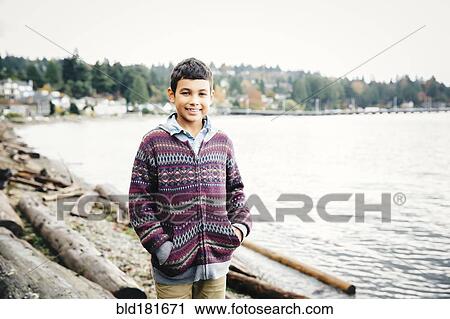 Mixed race boy walking on logs at lake View Large Photo Image Stock Image - Mixed race boy walking on logs at lake. Fotosearch