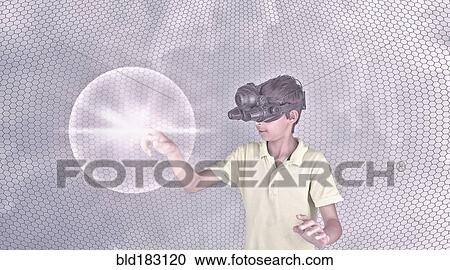 Stock Image - Mixed race boy wearing virtual reality goggles. Fotosearch