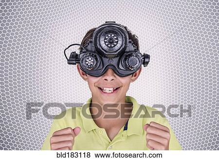 Stock Photo - Mixed race boy wearing virtual reality goggles. Fotosearch