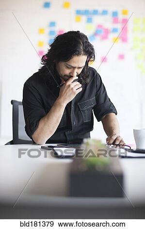 Mixed race businessman using digital tablet in office View Large Photo Image Stock Photo - Mixed race businessman using digital tablet in office. Fotosearch