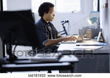 Mixed race businessman working in office View Large Photo Image Stock Image - Mixed race businessman working in office. Fotosearch