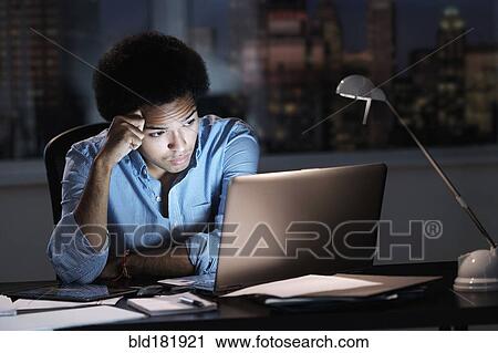 Mixed race businessman working late in office View Large Photo Image Stock Image - Mixed race businessman working late in office. Fotosearch