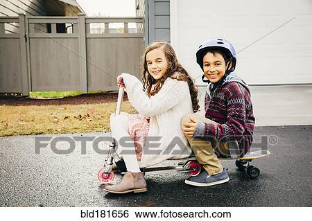 Stock Photograph - Mixed race children playing outdoors. Fotosearch