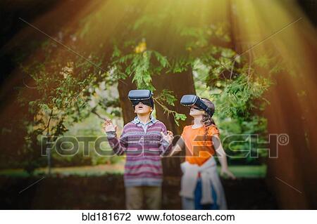 Mixed race children using virtual reality goggles outdoors View Large Photo Image Stock Image - Mixed race children using virtual reality goggles outdoors. Fotosearch