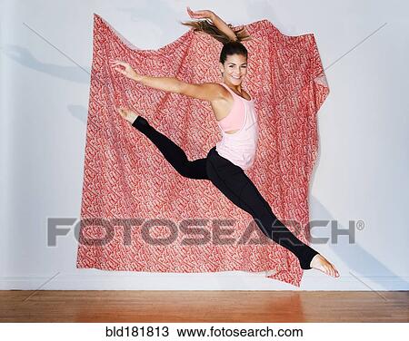 Stock Image - Mixed race dancer practicing in studio. Fotosearch