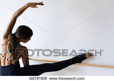 Stock Image - Mixed race dancer practicing in studio. Fotosearch