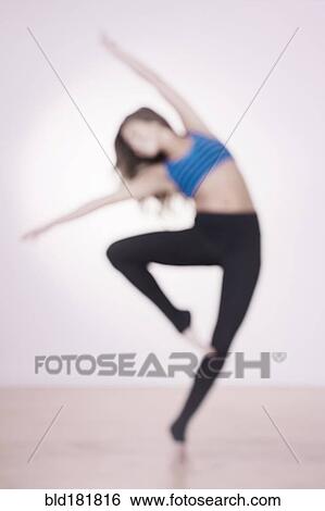 Stock Photograph - Mixed race dancer practicing in studio. Fotosearch