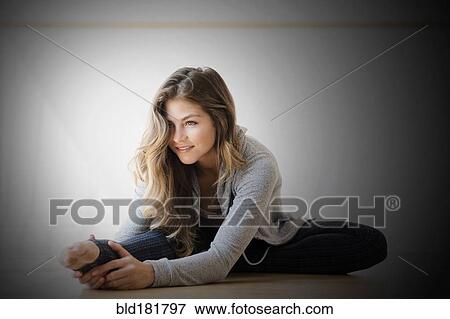Stock Photo - Mixed race dancer stretching in studio. Fotosearch