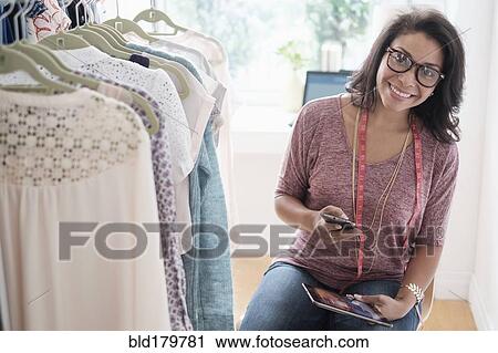 Stock Image - Mixed race designer working in studio. Fotosearch