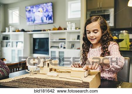 Mixed race girl building model house View Large Photo Image Stock Image - Mixed race girl building model house. Fotosearch