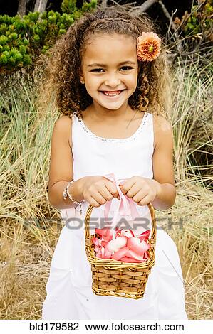Mixed race girl carrying flower basket View Large Photo Image Stock Image - Mixed race girl carrying flower basket. Fotosearch