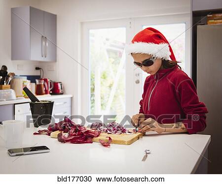 Mixed race girl cooking in Santa hat View Large Photo Image Stock Image - Mixed race girl cooking in Santa hat. Fotosearch