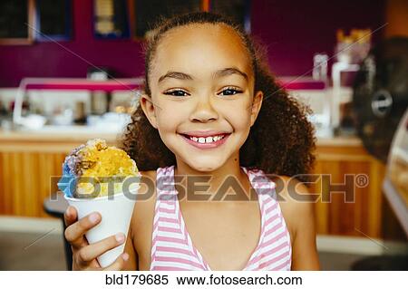 Mixed race girl holding snow cone View Large Photo Image Stock Photography - Mixed race girl holding snow cone. Fotosearch