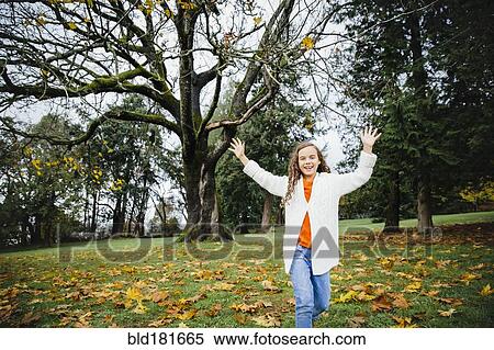 Stock Photography - Mixed race girl playing in park. Fotosearch