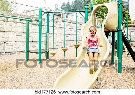 Mixed race girl playing on playground View Large Photo Image Stock Photograph - Mixed race girl playing on playground. Fotosearch