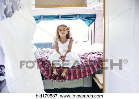 Mixed race girl sitting on trailer bed View Large Photo Image Stock Photo - Mixed race girl sitting on trailer bed. Fotosearch