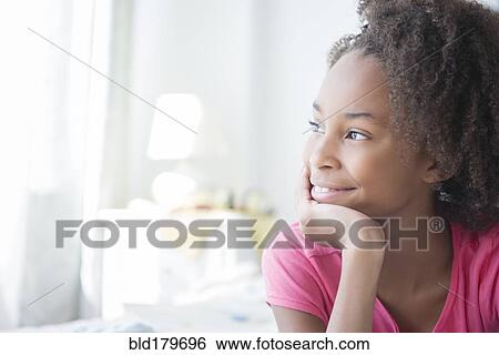 Mixed race girl smiling indoors View Large Photo Image Stock Photograph - Mixed race girl smiling indoors. Fotosearch