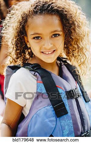 Stock Photo - Mixed race girl smiling outdoors. Fotosearch