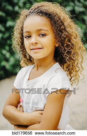 Mixed race girl smiling outdoors View Large Photo Image Stock Photograph - Mixed race girl smiling outdoors. Fotosearch