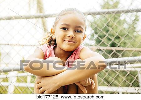 Stock Photography - Mixed race girl smiling outdoors. Fotosearch