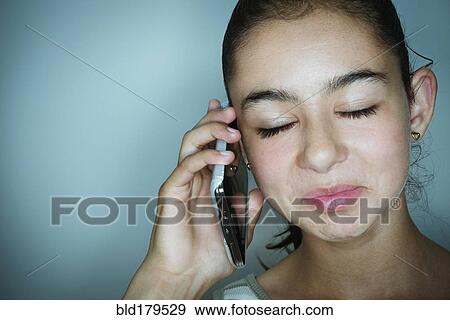 Mixed race girl talking on cell phone View Large Photo Image Stock Photo - Mixed race girl talking on cell phone. Fotosearch