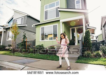 Mixed race girl twirling hoop on sidewalk View Large Photo Image Stock Image - Mixed race girl twirling hoop on sidewalk. Fotosearch
