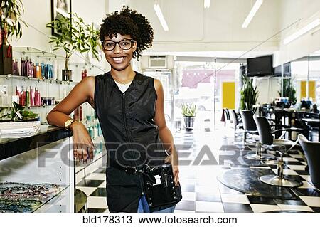 Mixed race hairstylist smiling in salon View Large Photo Image Stock Image - Mixed race hairstylist smiling in salon. Fotosearch