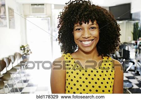 Mixed race hairstylist smiling in salon View Large Photo Image Stock Photo - Mixed race hairstylist smiling in salon. Fotosearch