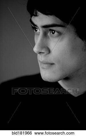 Stock Photograph - Mixed race man looking up. Fotosearch