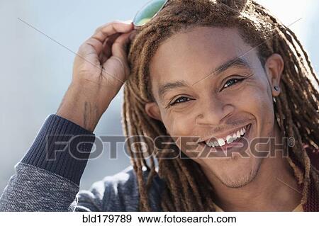 Stock Photo - Mixed race man smiling. Fotosearch