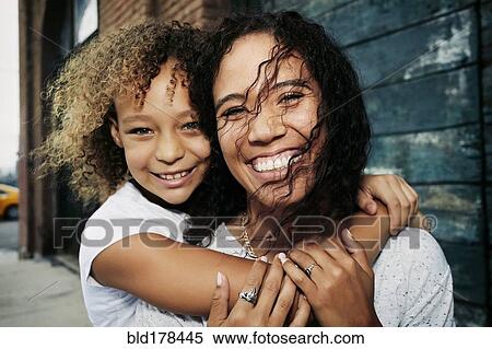 Mixed race mother and daughter hugging outdoors View Large Photo Image Stock Photography - Mixed race mother and daughter hugging outdoors. Fotosearch